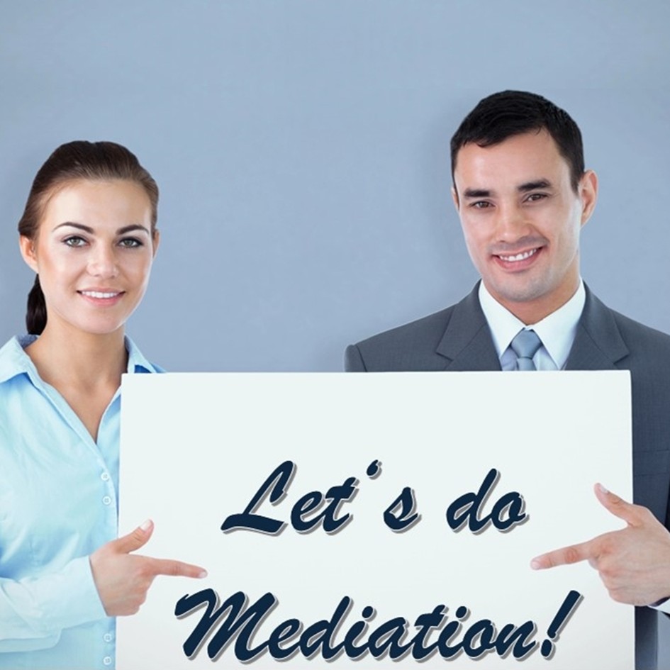 Smiling business people hold a large white sign that reads ‘LET'S DO MEDIATION’.